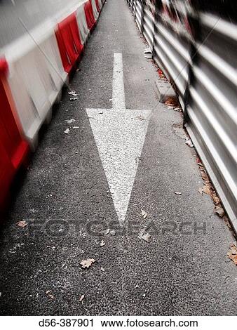 Stock Image - Arrow sign in asphalt, Valencia, Spain. Fotosearch
