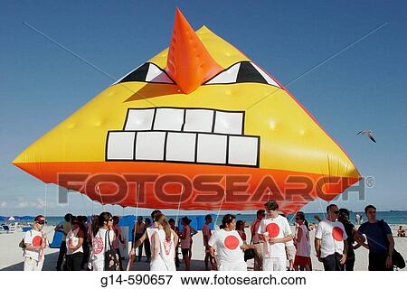 Stock Photo - ArtCenter South Florida benefit, volunteers. Skywalkers Giant Blimp Parade. Atlantic Shore. Miami Beach. Florida. USA.. Fotosearch