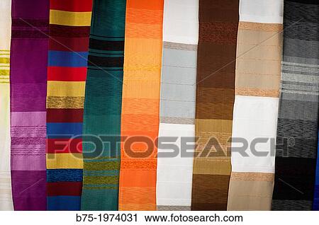Stock Image - Artisan carpets handwoven at a street market in Fez, Morocco, Africa. Fotosearch