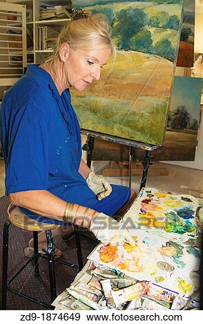 Artist Mya Louw mixes colors for a painting View Large Photo Image Stock Photo - Artist Mya Louw mixes colors for a painting. Fotosearch