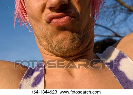 Stock Image - As a woman dressed man celebrating the carnival in Munich. Fotosearch