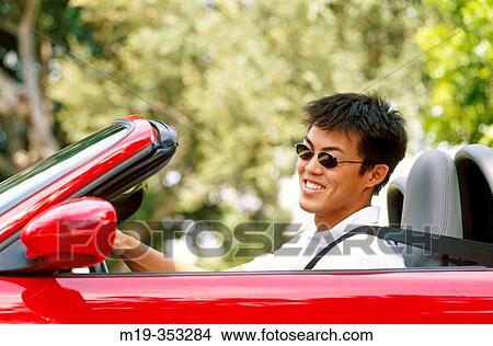 Asain man in a convertible View Large Photo Image Picture - Asain man in a convertible. Fotosearch