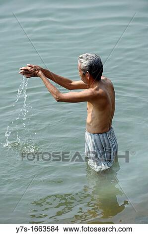 Asia, India, State of Madhya Pradesh, Omkareshwar, praying man in the Ganges River View Large Photo Image Picture - Asia, India, State of Madhya Pradesh, Omkareshwar, praying man in the Ganges River. Fotosearch