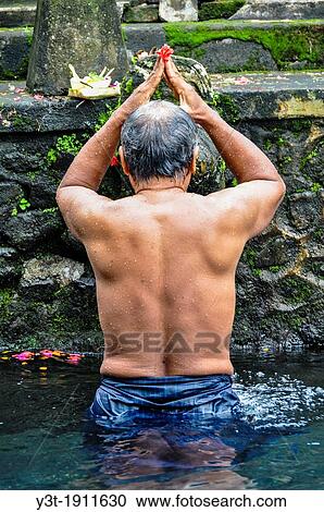Asia, South-East Asia, Indonesia, Bali. Tampaksiring. Outskirts of Ubud. Temple Pura Tirta Empul, bath in the sacred source of Tampaksiring. View Large Photo Image Stock Image - Asia, South-East Asia, Indonesia, Bali. Tampaksiring. Outskirts of Ubud. Temple Pura Tirta Empul, bath in the sacred source of Tampaksiring.. Fotosearch