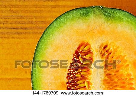 Stock Photo - Asia, Thailand, Bangkok, musk melon cut open against corrugated cardboard. Fotosearch
