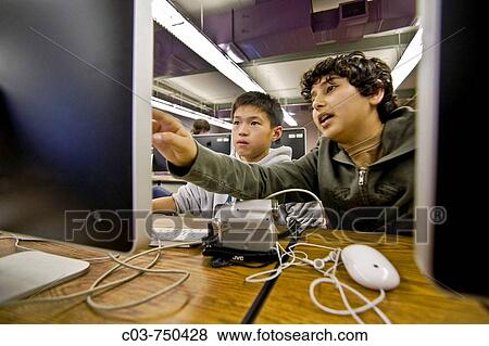 Asian and Hispanic middle school students work cooperatively at flat-panel monitors in their school computer class View Large Photo Image Stock Photo - Asian and Hispanic middle school students work cooperatively at flat-panel monitors in their school computer class. Fotosearch