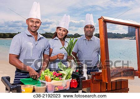 Stock Image - Asian catering chefs at the beach cooking with a Koththu station. Gold Coast, Queensland, Australia.. Fotosearch