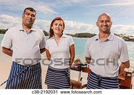 Stock Image - Asian catering chefs at the beach cooking with a Koththu station. Gold Coast, Queensland, Australia.. Fotosearch