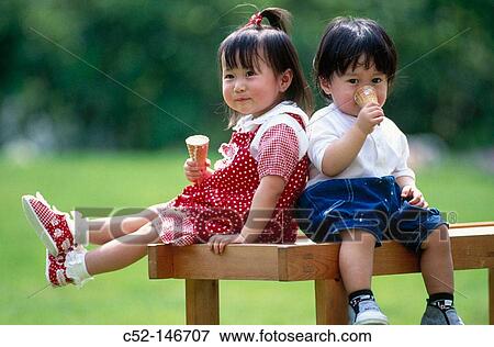 Stock Photo - Asian children eating ice-cream. Fotosearch
