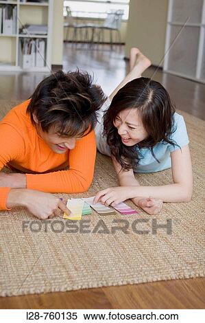 Asian couple looking at color paper View Large Photo Image Stock Photography - Asian couple looking at color paper. Fotosearch