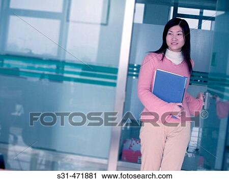 Asian female entering a room for an interview View Large Photo Image Stock Image - Asian female entering a room for an interview. Fotosearch