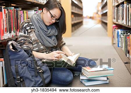 Asian female student reading books at a university library View Large Photo Image Picture - Asian female student reading books at a university library. Fotosearch