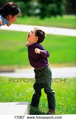Asian girl and young boy yelling at each other View Large Photo Image Stock Photo - Asian girl and young boy yelling at each other. Fotosearch