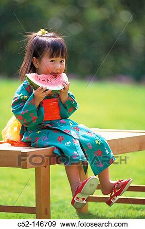 Asian girl eating water melon View Large Photo Image Stock Photo - Asian girl eating water melon. Fotosearch