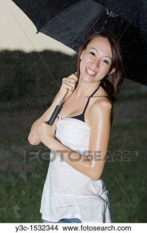 Asian girl in the rain View Large Photo Image Picture - Asian girl in the rain. Fotosearch
