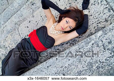 Asian girl laying on the stairs of Piazza di Spagna Rome Italy View Large Photo Image Stock Photo - Asian girl laying on the stairs of Piazza di Spagna Rome Italy. Fotosearch