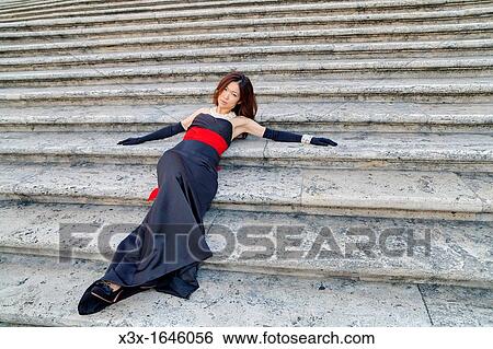 Asian girl laying on the stairs of Piazza di Spagna Rome Italy View Large Photo Image Stock Photograph - Asian girl laying on the stairs of Piazza di Spagna Rome Italy. Fotosearch