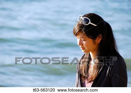 asian girl walking alone on beach View Large Photo Image Stock Image - asian girl walking alone on beach. Fotosearch