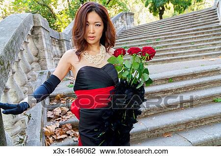 Asian girl with red roses posing on stairs Rome Italy View Large Photo Image Stock Image - Asian girl with red roses posing on stairs Rome Italy. Fotosearch