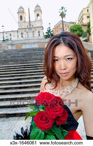Asian girl with red roses posing on the stairs of Piazza di Spagna Rome Italy View Large Photo Image Stock Image - Asian girl with red roses posing on the stairs of Piazza di Spagna Rome Italy. Fotosearch