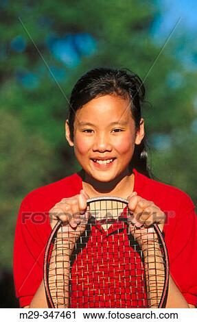 Stock Image - Asian girl with tennis racket. Fotosearch