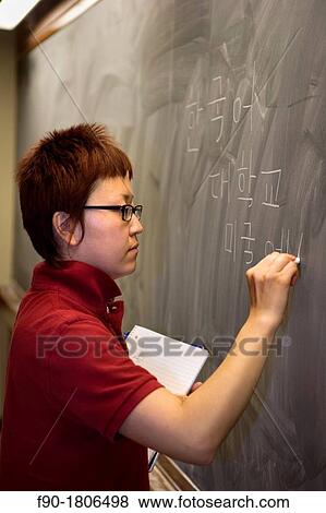 Asian graduate student at blackboard View Large Photo Image Stock Photo - Asian graduate student at blackboard. Fotosearch