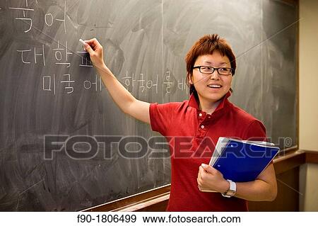 Asian graduate student at blackboard View Large Photo Image Stock Photo - Asian graduate student at blackboard. Fotosearch