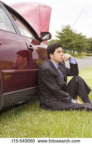 Asian man in his 30's have a cigarette to calm down after the car broke down on the road. submission # 067387 View Large Photo Image Stock Image - Asian man in his 30's have a cigarette to calm down after the car broke down on the road. submission # 067387. Fotosearch