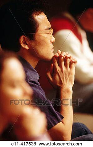 Stock Photo - Asian man in prayer.. Fotosearch