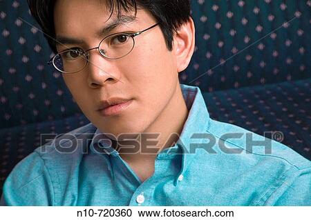 Asian man, wearing glasses, posing. View Large Photo Image Stock Image - Asian man, wearing glasses, posing.. Fotosearch