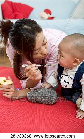 Asian mother With baby View Large Photo Image Stock Photo - Asian mother With baby. Fotosearch