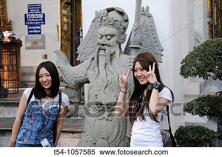 Asian Touristinen take a picture of a temple guardian at Wat Pho and himself, Bangkok, Thailand View Large Photo Image Stock Photography - Asian Touristinen take a picture of a temple guardian at Wat Pho and himself, Bangkok, Thailand. Fotosearch