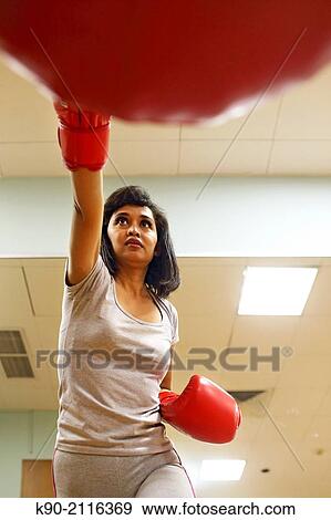 Asian woman doing boxing exercises with big red gloves, Jakarta, Indonesia, Southeast Asia. View Large Photo Image Stock Photo - Asian woman doing boxing exercises with big red gloves, Jakarta, Indonesia, Southeast Asia.. Fotosearch