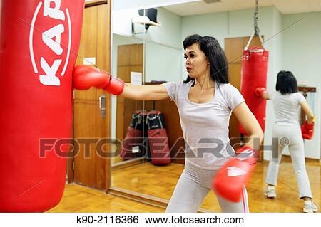 Asian woman doing boxing exercises with red gloves, Jakarta, Indonesia, Southeast Asia. View Large Photo Image Stock Photograph - Asian woman doing boxing exercises with red gloves, Jakarta, Indonesia, Southeast Asia.. Fotosearch