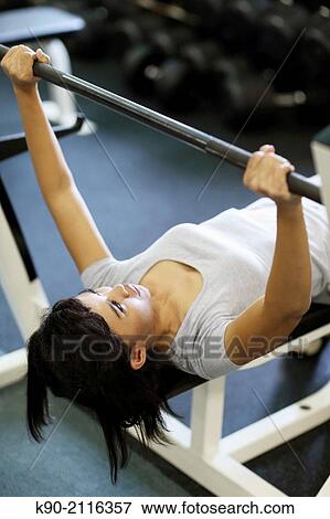 Asian woman doing weightlifting at a rack, Jakarta, Indonesia, Southeast Asia. View Large Photo Image Stock Photo - Asian woman doing weightlifting at a rack, Jakarta, Indonesia, Southeast Asia.. Fotosearch