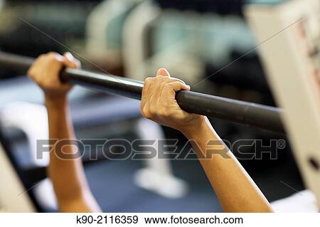 Asian woman doing weightlifting at a rack, Jakarta, Indonesia, Southeast Asia. View Large Photo Image Stock Photo - Asian woman doing weightlifting at a rack, Jakarta, Indonesia, Southeast Asia.. Fotosearch
