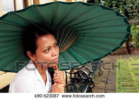 Asian woman holding a paper made umbrella at Losari Coffee Plantation in West Java, Indonesia, South East Asia View Large Photo Image Stock Photo - Asian woman holding a paper made umbrella at Losari Coffee Plantation in West Java, Indonesia, South East Asia. Fotosearch