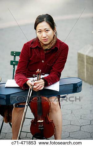 Asian woman holding violin View Large Photo Image Stock Image - Asian woman holding violin. Fotosearch