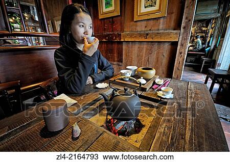 Stock Image - Asian woman in an old teahouse at "Jiufen Tea House". Taiwan (China), New Taipei City, Ruifang, Jiufen (Chiufen). Model Released.. Fotosearch