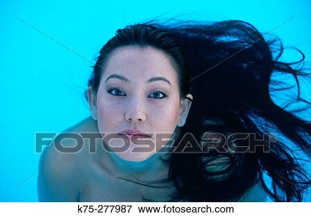 Asian woman in pool with hair flowing View Large Photo Image Stock Photo - Asian woman in pool with hair flowing. Fotosearch