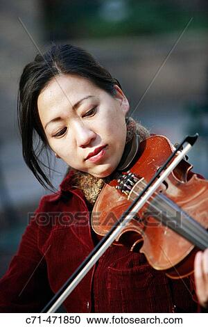 Asian woman playing the violin View Large Photo Image Stock Image - Asian woman playing the violin. Fotosearch