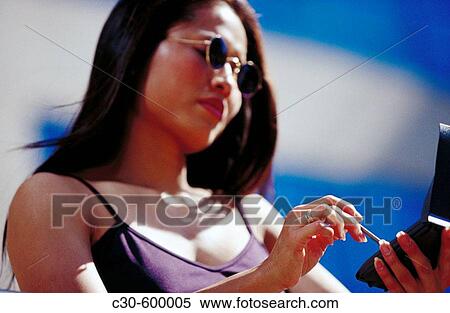 Stock Photography - Asian woman using PDA.. Fotosearch