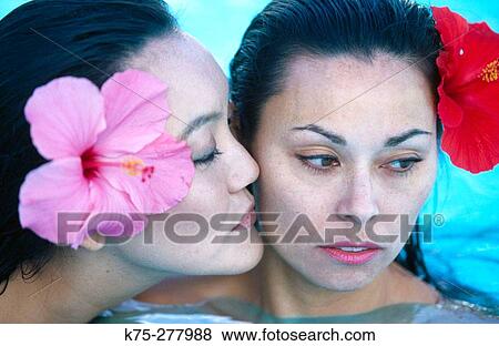 Stock Photo - Asian women kiss in pool. Fotosearch
