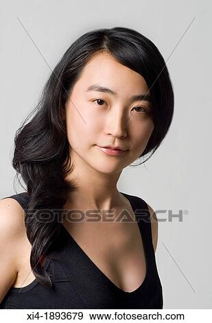 Asian young female looking into the camera white background View Large Photo Image Stock Photo - Asian young female looking into the camera white background. Fotosearch