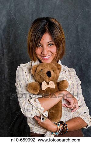 Asian/Spanish teen girl cuddling a stuffed animal. View Large Photo Image Stock Image - Asian/Spanish teen girl cuddling a stuffed animal.. Fotosearch