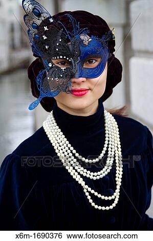 Stock Photograph - asiatic woman with mask and fancy dress in carnival Venice, Italy. Fotosearch