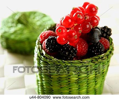 Stock Image - Assorted berry little green basket Variety of berries. Fotosearch