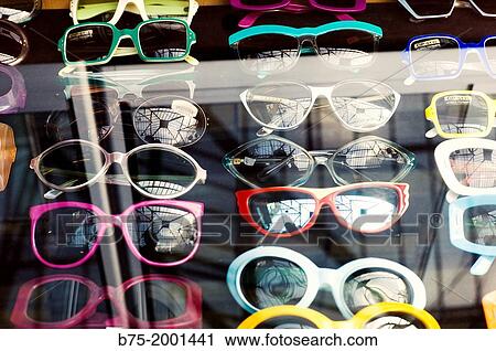 Assortment of sunglasses displayed in a showcase View Large Photo Image Stock Image - Assortment of sunglasses displayed in a showcase. Fotosearch