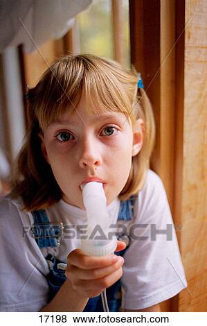 Asthmatic girl using inhaler View Large Photo Image Stock Photo - Asthmatic girl using inhaler. Fotosearch