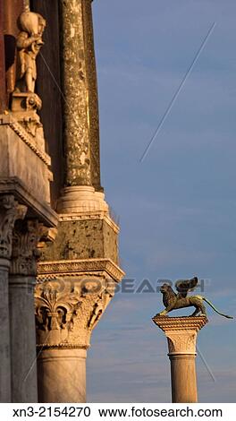 At left Saint Mark's Basilica, Winged Lion column, St Mark's square, Venice, Veneto, Italy, Europe. View Large Photo Image Stock Image - At left Saint Mark's Basilica, Winged Lion column, St Mark's square, Venice, Veneto, Italy, Europe.. Fotosearch